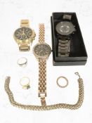 A silver gilt dress ring stamped 925, a further CZ ring stamped 925, an eternity ring,