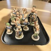 Fifteen Goebel figurines of boys and girls.