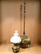 A Victorian beech and brass bed warming pan and a brass oil lamp with opaque shade.