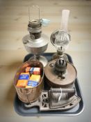 A group of oil lamps, iron and trivet, copper twin handled planter.