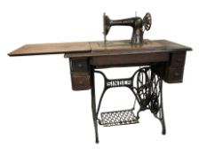 A Singer treadle sewing machine in oak table.