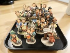 Fifteen Goebel figurines of boys and girls.