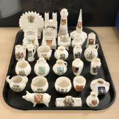 A group of Goss and other crested china including various jugs, vases, figures, etc.