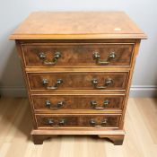 A small reproduction yew wood four drawer chest, width 49 cm.