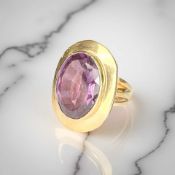 A faceted amethyst ring, foreign marks to yellow metal shank,
