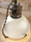 An early 20th century pendant light fitting with copper plated mount and ribbed opaque glass shade,