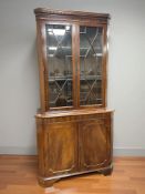 A reproduction mahogany corner cabinet,