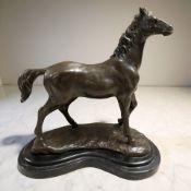 A reproduction patinated bronze figure of a horse on black marble stepped plinth, length 29 cm.