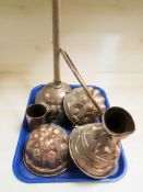 Three copper jelly moulds, a poss stick and a mug.