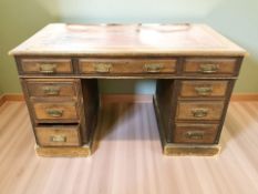 A Victorian mahogany nine drawer twin pedestal desk with tooled leather writing surface,