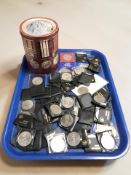 A collection of assorted crowns, tin decorated with British medals.