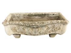 A weathered concrete garden planter,