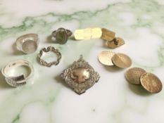 Four silver/white metal dress rings, a pair of silver cuff links, a further plated pair,