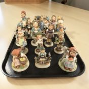 Fifteen Goebel figurines of boys and girls.