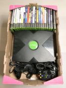 An Xbox with leads, controllers, several games.