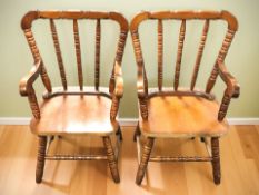 A pair of reproduction child's spindle back carver chairs, width 43 cm.