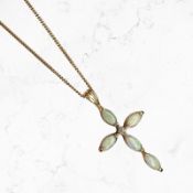 A 9ct gold opal and diamond crucifix pendant on 9ct gold chain CONDITION REPORT: 2.