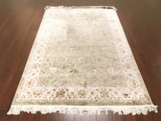 A machine made rug of Iranian design,