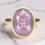 A faceted amethyst ring, stamped 18K, size R CONDITION REPORT: 6.