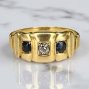 An antique sapphire and diamond three stone ring, marks rubbed,