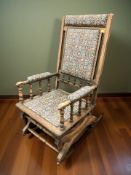 An Edwardian rocking chair in floral fabric.
