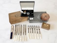 An Arts & Crafts hammered pewter-covered box depicting cherubs, together with further vacant boxes,