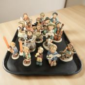 Fifteen Goebel figurines of boys and girls.