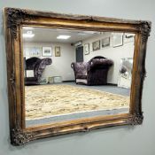 An antique style bevelled gilt framed mirror, 150 cm x 119 cm.