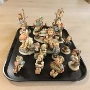 Fifteen Goebel figurines of boys and girls.