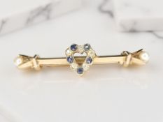 A Victorian 15ct yellow gold bar brooch set with a heart encrusted with old cut diamonds and