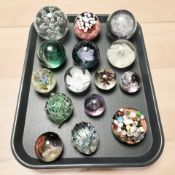 A collection of glass paperweights including Murano, Caithness, etc.