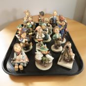 Fifteen Goebel figurines of boys and girls.