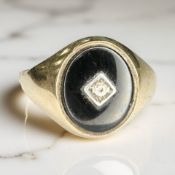A 9ct gold black onyx and diamond signet ring, size V CONDITION REPORT: 3.