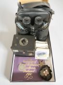 A pair of Tasco 10x50mm binoculars, a Brownie camera, Wills cigarette cards,
