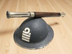 A sea captain's tin brodie helmet, and a leather and chrome telescope by Gieves Limited.