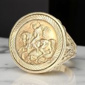 A 9ct gold signet ring inset with a yellow metal Sovereign-style token with plain reverse,