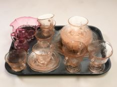 A group of etched peach glass cups and saucers,