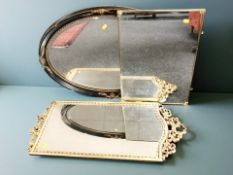 An ebonised and gilt oval mirror, width 82 cm,