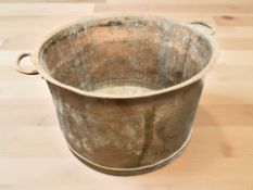 A large 19th century twin-handled copper circular vessel,