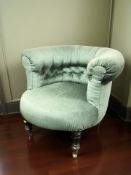 A Victorian salon tub chair in buttoned green fabric,