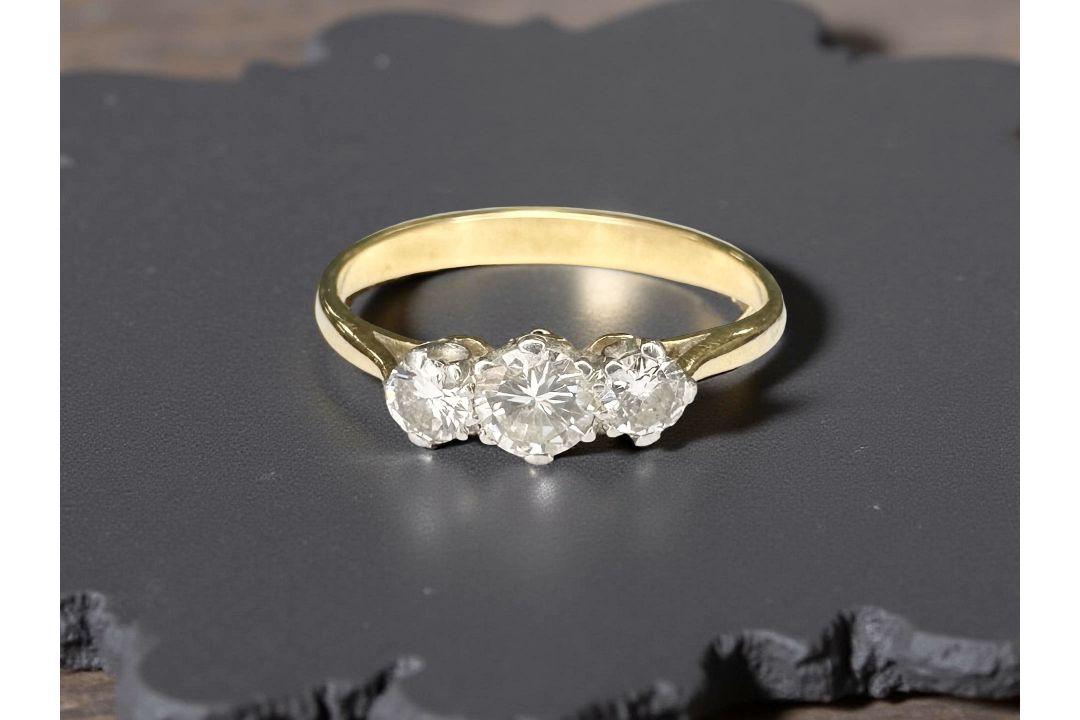 An 18ct yellow gold three stone diamond ring, size P. CONDITION REPORT: Weight: 2.9g.
