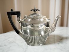 A silver teapot, Walker & Hall, Sheffield marks, with ebony handle, inscription dated 1890-1915,