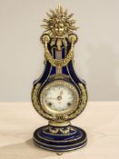 A decorative Victoria and Albert Museum replica 'Marie Antoinette' mantel clock with movement
