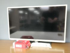A Bush 32 inch LCD TV with lead and remote