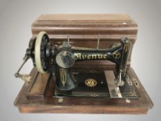 An Avenue hand sewing machine in wooden case