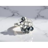 An 18ct gold sapphire and diamond ring, approximately 1.1ct, size N.
