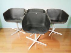 Four Scandinavian moulded plastic swivel dining chairs on painted metal supports designed by Rudi