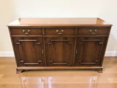 A reproduction yew wood sideboard,