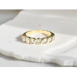 An 18ct gold diamond half eternity ring, approximately 0.45 carat.