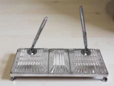 A cut crystal desk set with two pens on chrome base with claw and ball feet,
